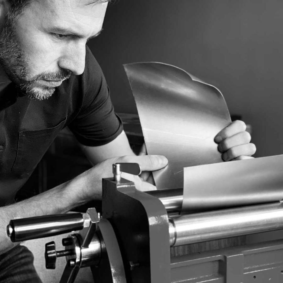 British craftsman creating a shade by hand for the Arcform ARC 25 luxury modern chandelier, supplied by South Charlotte Fine Lighting