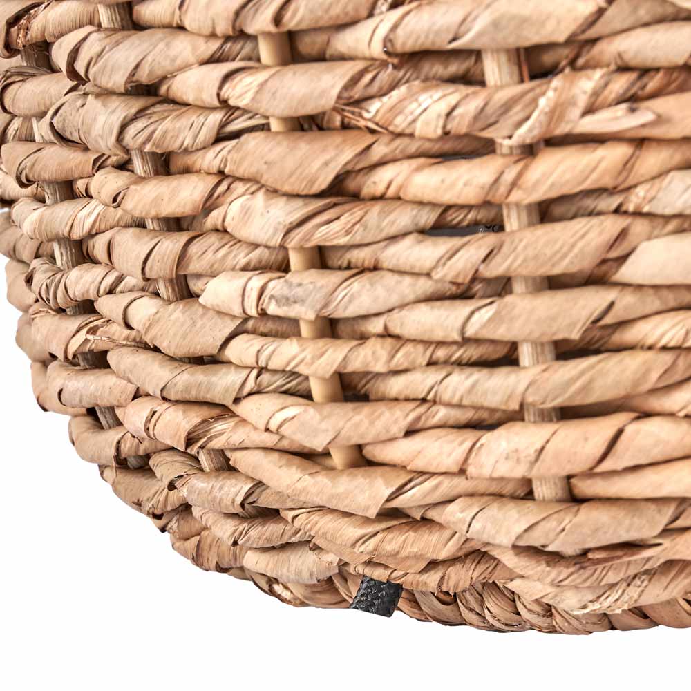 The Acer natural table lamp base is handwoven from seagrass