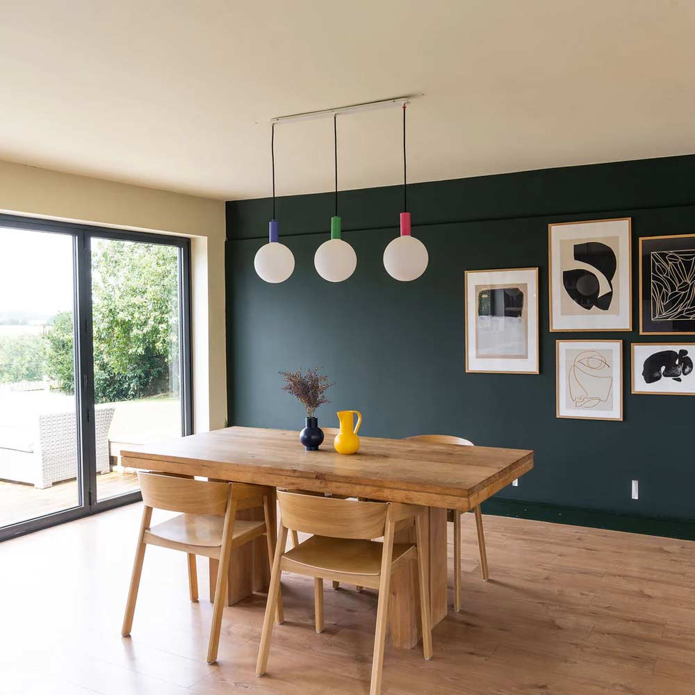Well Lit Aspen G200 LED Bulbs being used in a linear arrangement above a dining table.