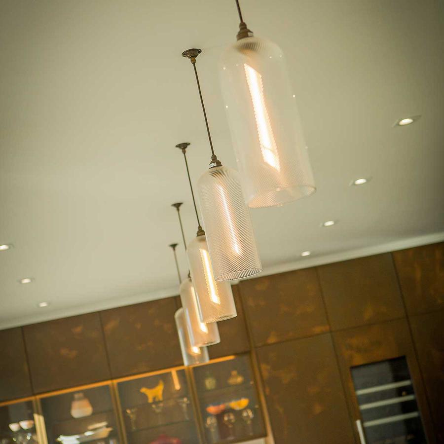 Glass pendant lighting over dining room table