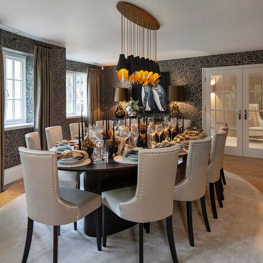 The Arcform ARC 25 modern black chandelier with a gold lacquer finish is ideal as a dining room chandelier, as pictured