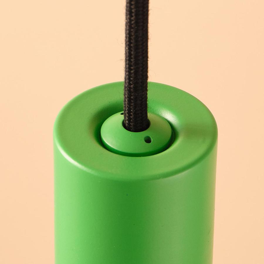 The Well Lit Spin in Serene Green features a pendant body made from recycled materials and black cable and is sold by South Charlotte Fine Lighting
