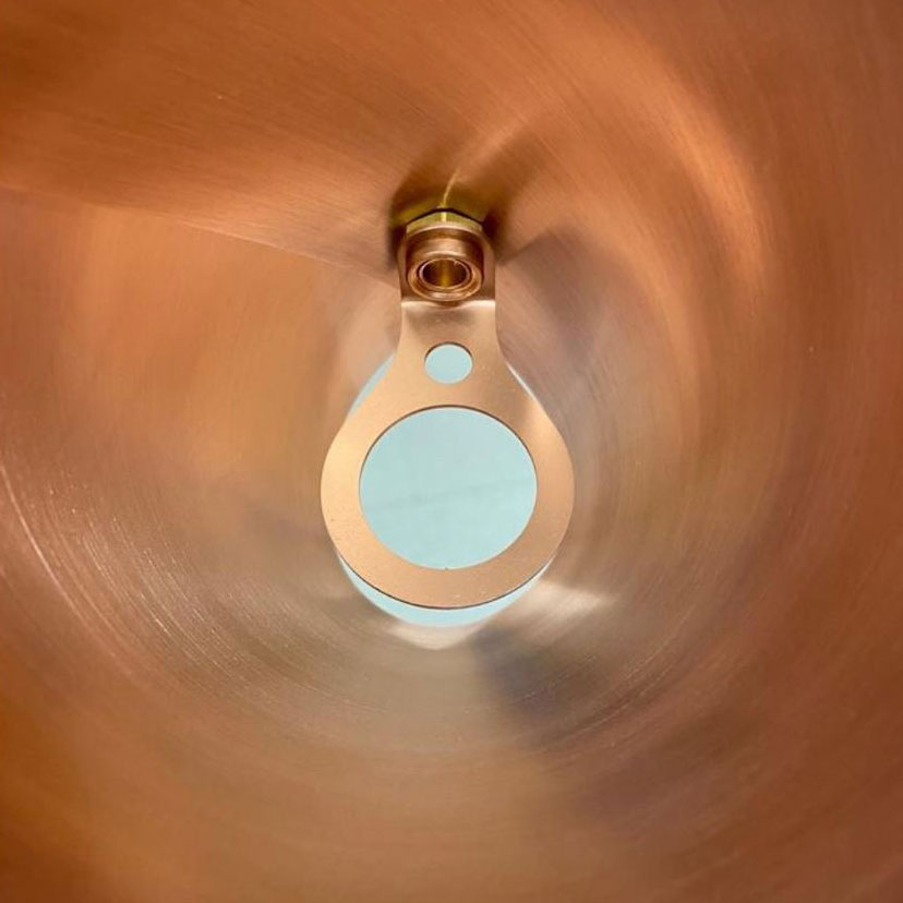 Brushed copper detailing on the inside of a shade on the modern chandelier, ARC 25, made by Arcform and supplied by South Charlotte Fine Lighting