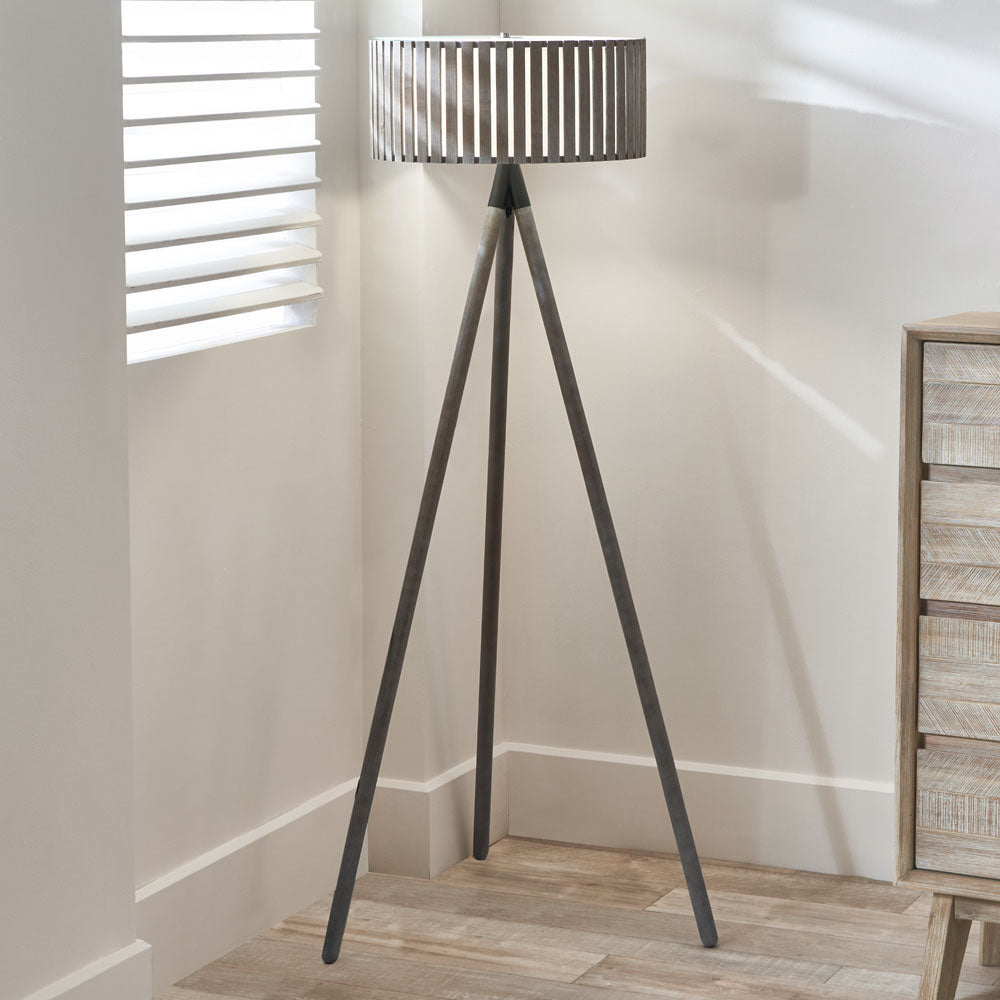 The Rabanne in antique wood is a floor lamp tripod wood