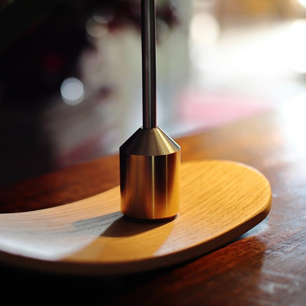 Brass weight on rocker of B-Type Balance Lamp is used to extend or retract it – the lamp is sold by South Charlotte Fine Lighting