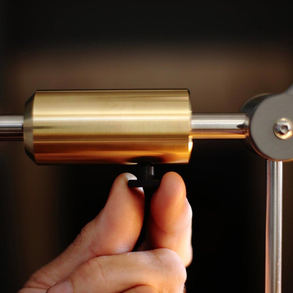 Adjust this contemporary desk lamp by turning this screw.