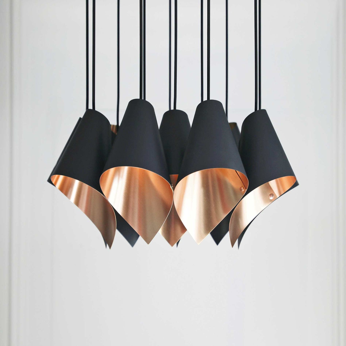 The ARC 12 contemporary chandelier in brushed copper from Arcform, supplied by South Charlotte Fine Lighting