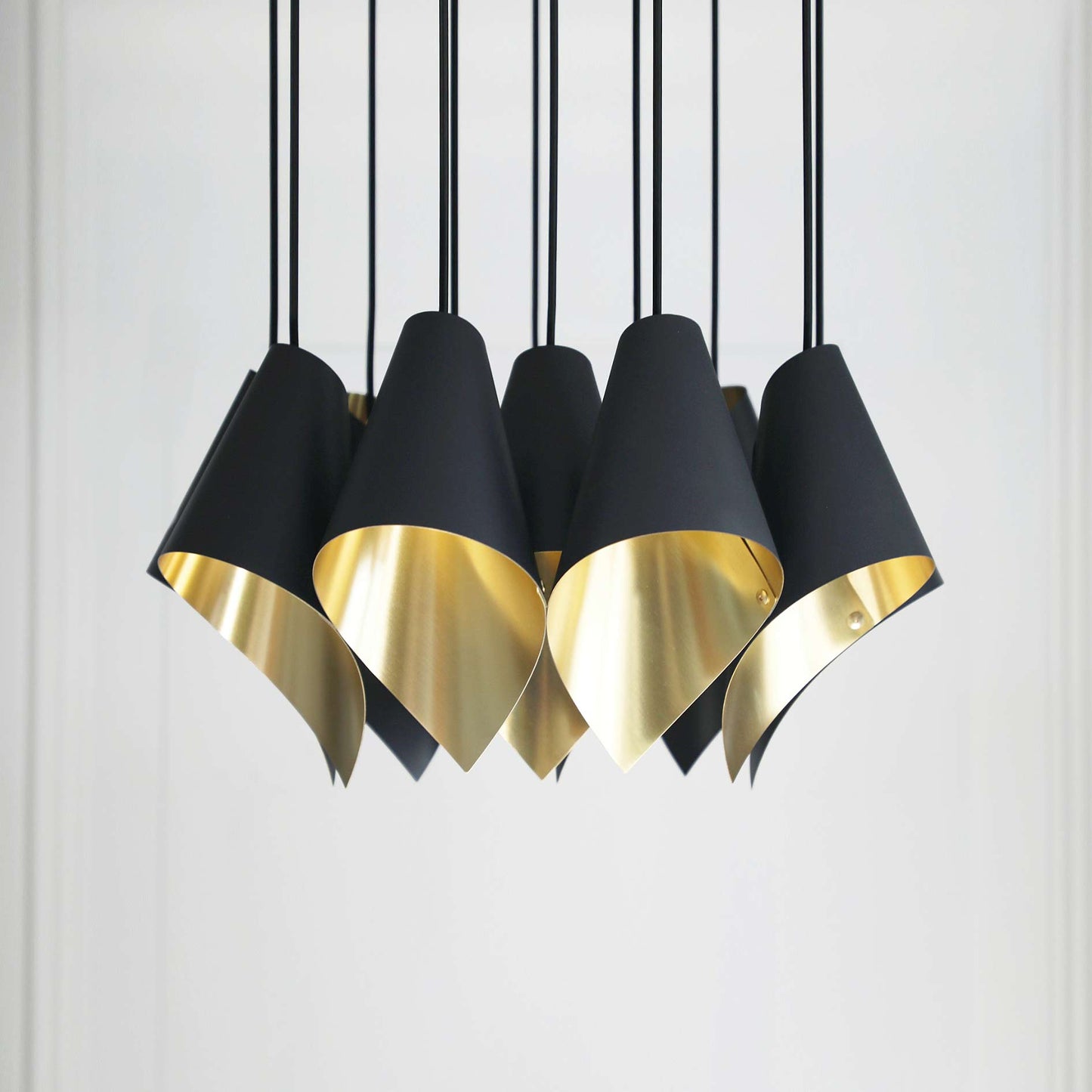 The Arcform ARC 12 modern chandelier in brushed brass is supplied by South Charlotte Fine Lighting and includes 12 contemporary lights in a cluster