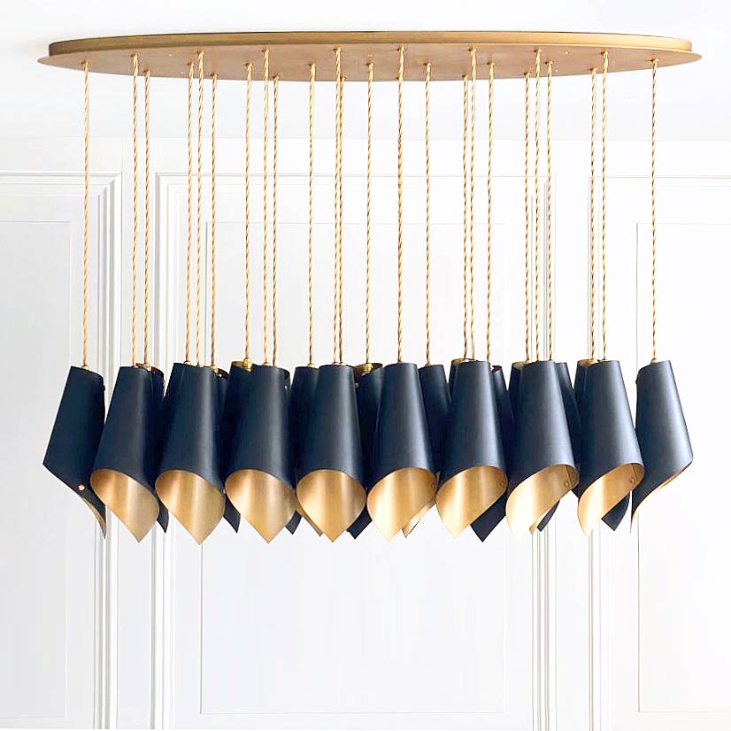 The Arcform ARC 25 modern black chandelier is shown here with a gold lacquer finish on the inside of the shades, supplied by South Charlotte Fine Lighting