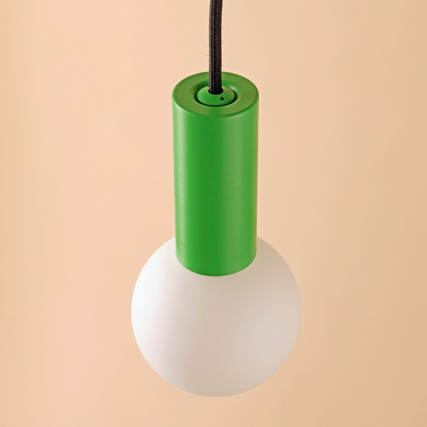 Well Lit Spin Pendant Light in Serene Green, pictured here with the Well Lit Azure G95 LED Light bulb