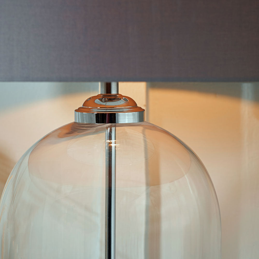 Cloche glass table lamp with silver rod through the centre of the base to ensure a balanced look