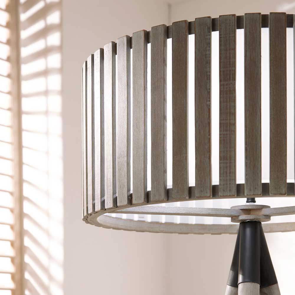 The standout feature of the Rabanne floor lamp tripod wood is its wooden slatted shade