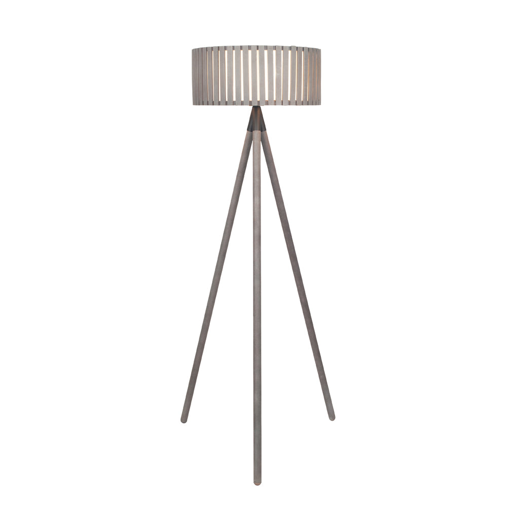 The Rabanne floor lamp tripod made from wood with its light illuminated