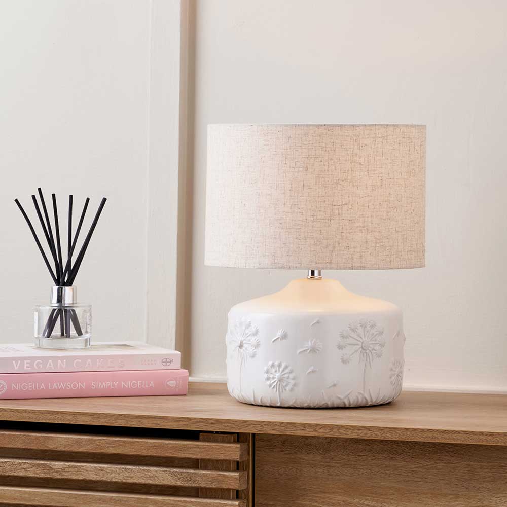 Flora White Small Floral Ceramic Table Lamp shown here on a sideboard