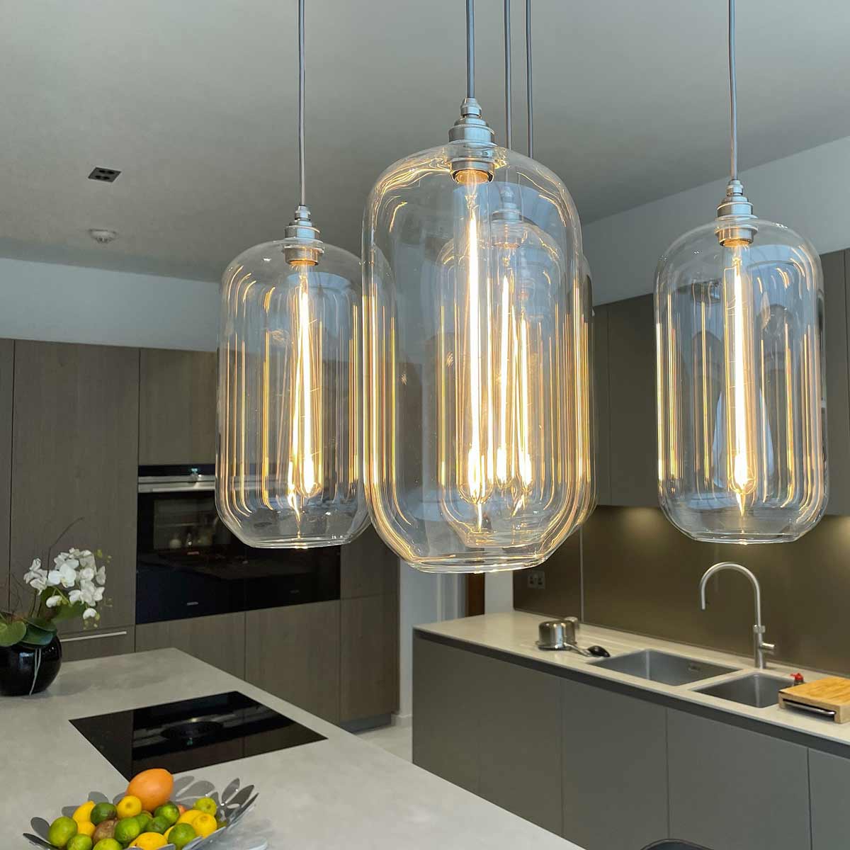 A cluster of Charlton Pendant Lights about a kitchen island