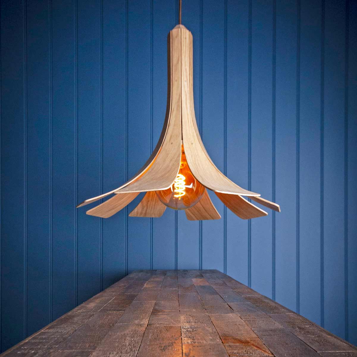 Wooden pendant light sold by South Charlotte Fine Lighting is ideal for kitchen table lighting or dining room table lighting