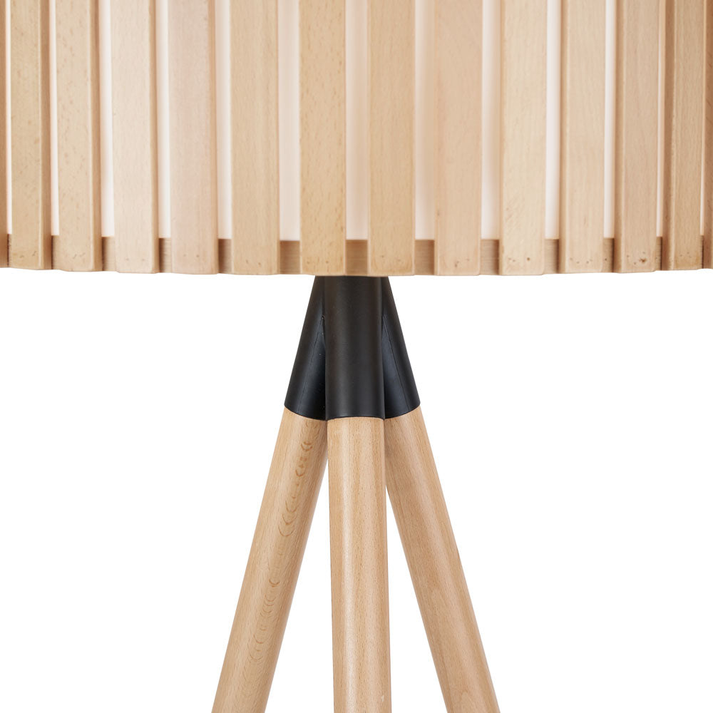 The Rabanne stand lamp made from wood has a diffuser behind its slatted shade