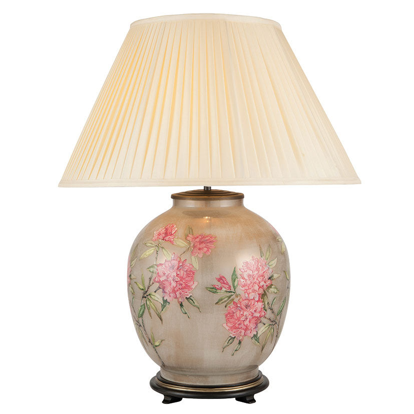 Vintage floral table lamp lit with empire-style lampshade