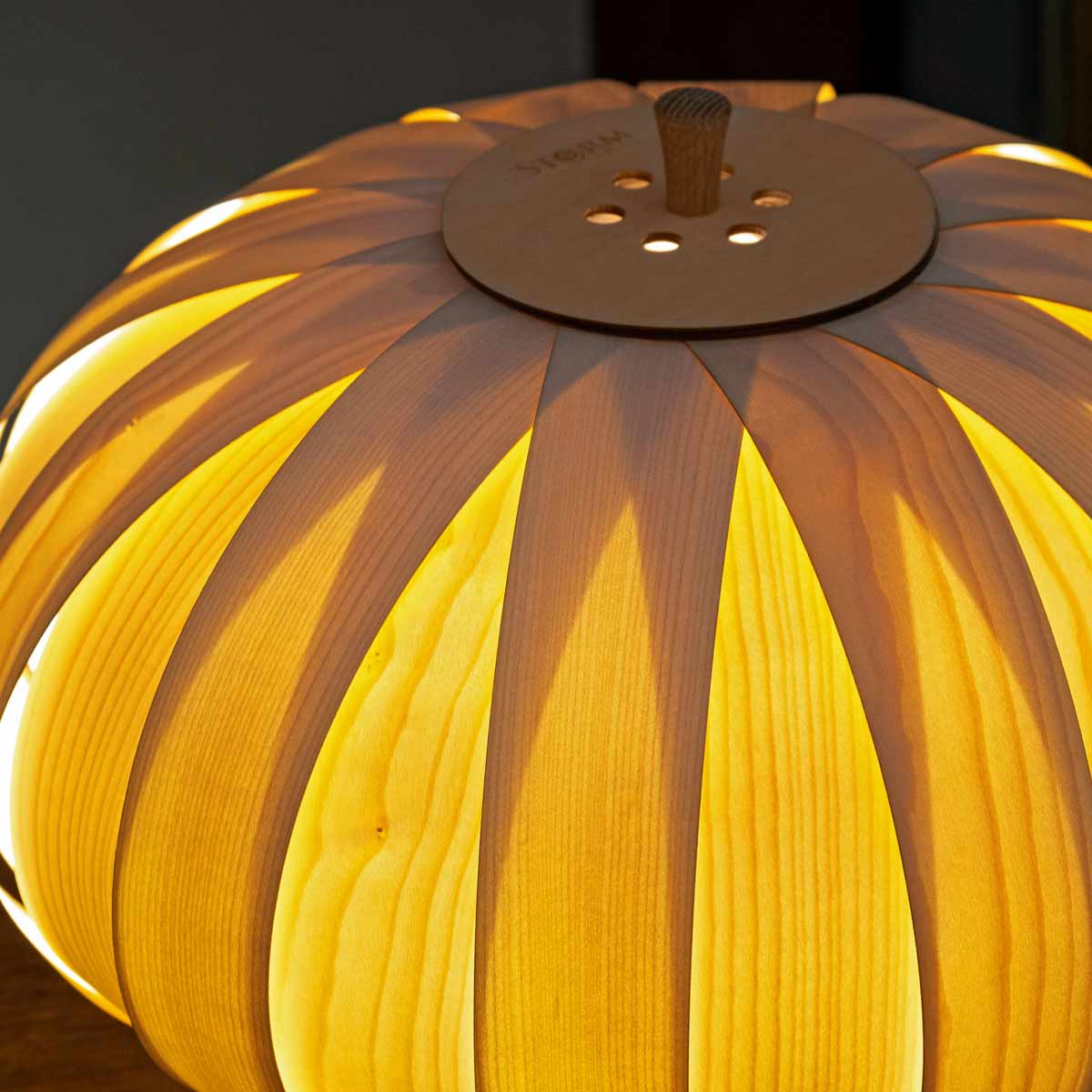 The Baby Bloom tripod lamp sold by South Charlotte Fine Lighting gives a warm glow