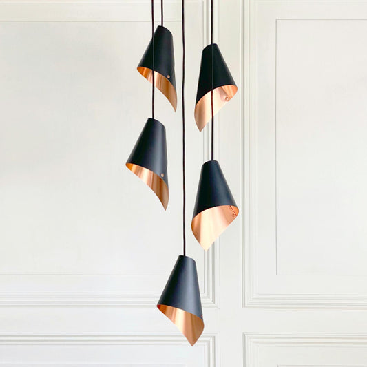 Pendant lights in copper and black made by Arcform and supplied by South Charlotte Fine Lighting.