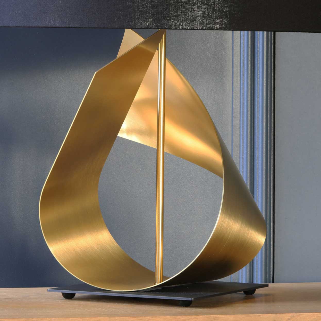 Handmade FLUX table lamp’s sweeping brass curves make it perfect for your living room