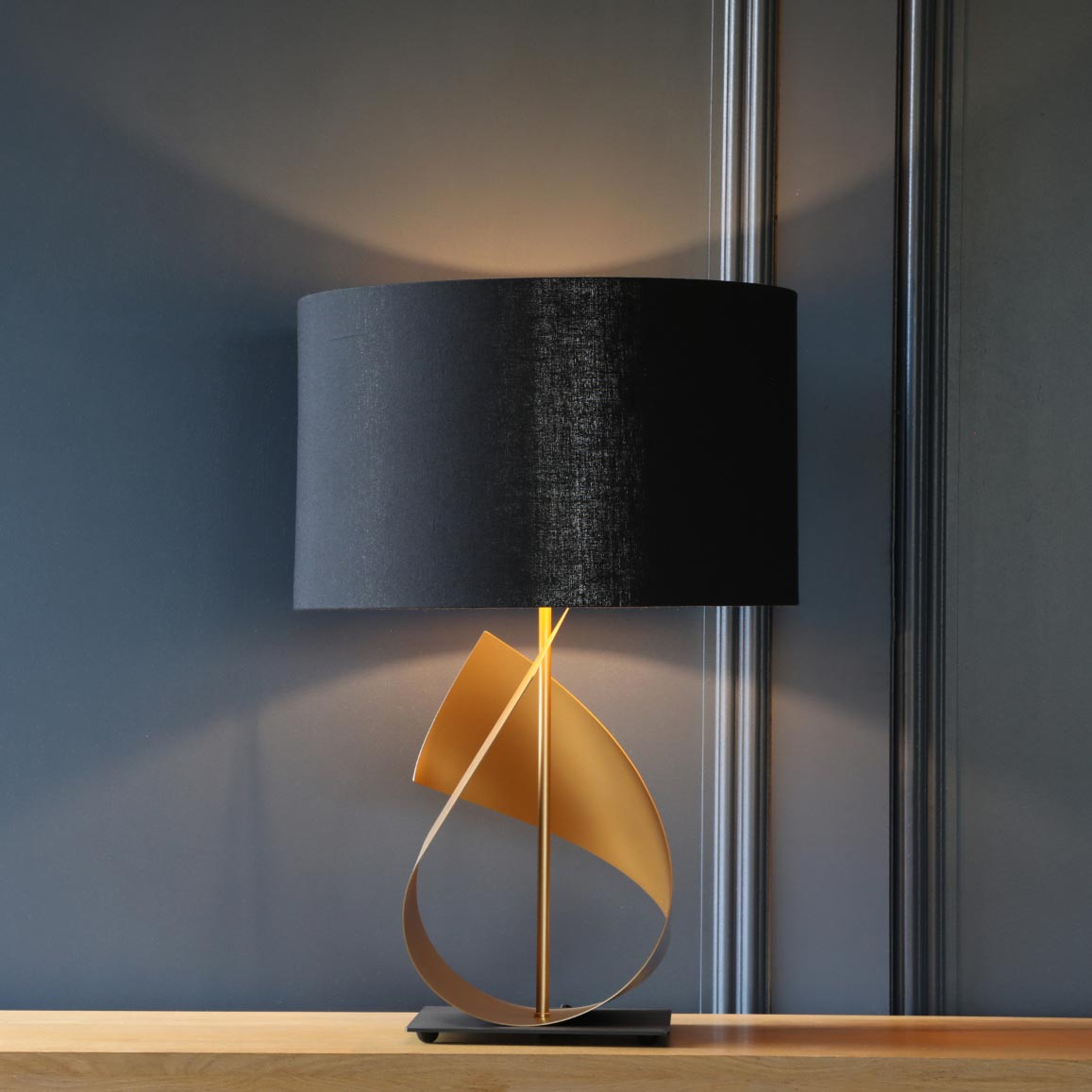 South Charlotte Supplied FLUX table lamp in gold with an optional blue shade.