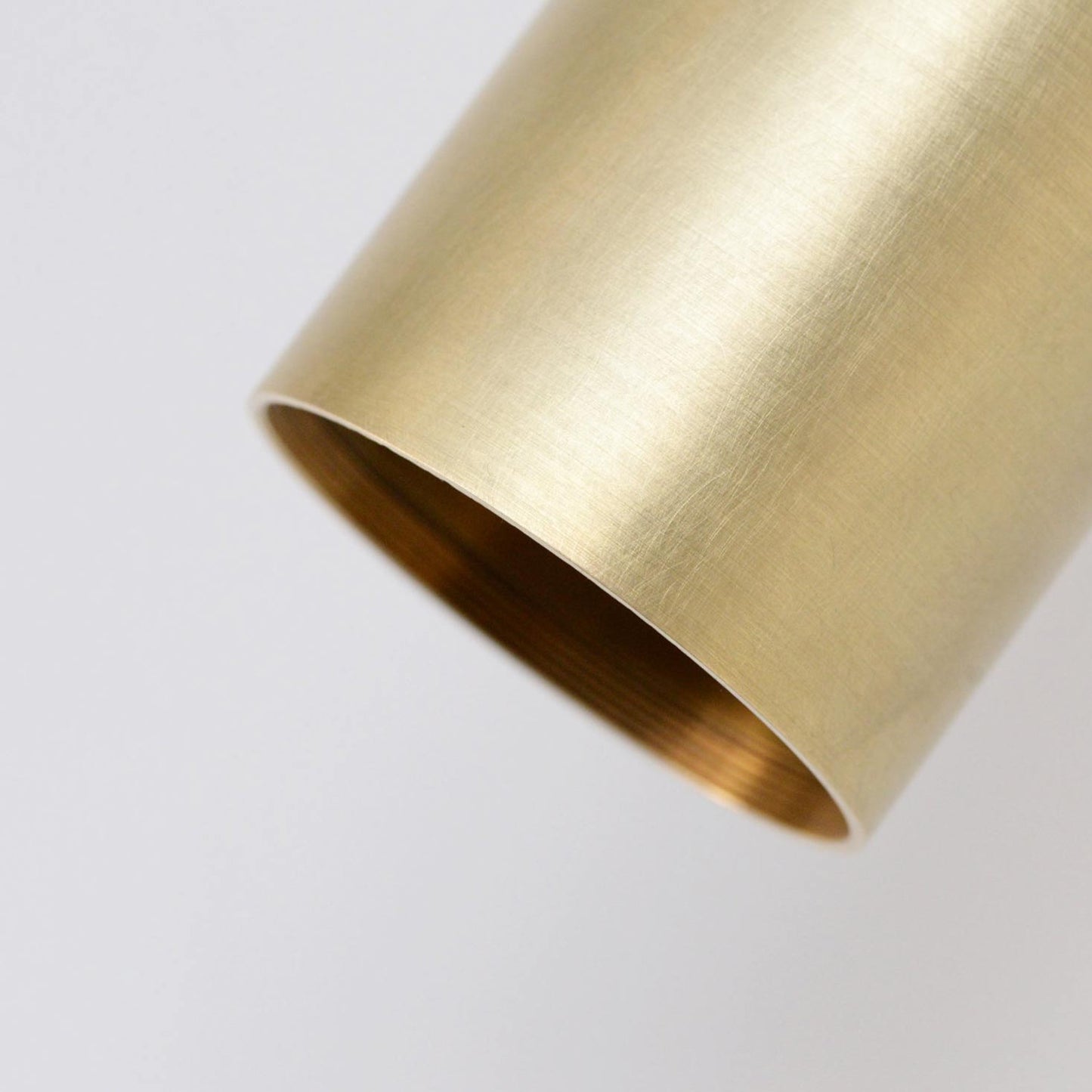 Detail on Arcform VIDERE ceiling light in brushed brass. This premium ceiling light can be used as a living room ceiling light and is supplied by South Charlotte Fine lighting